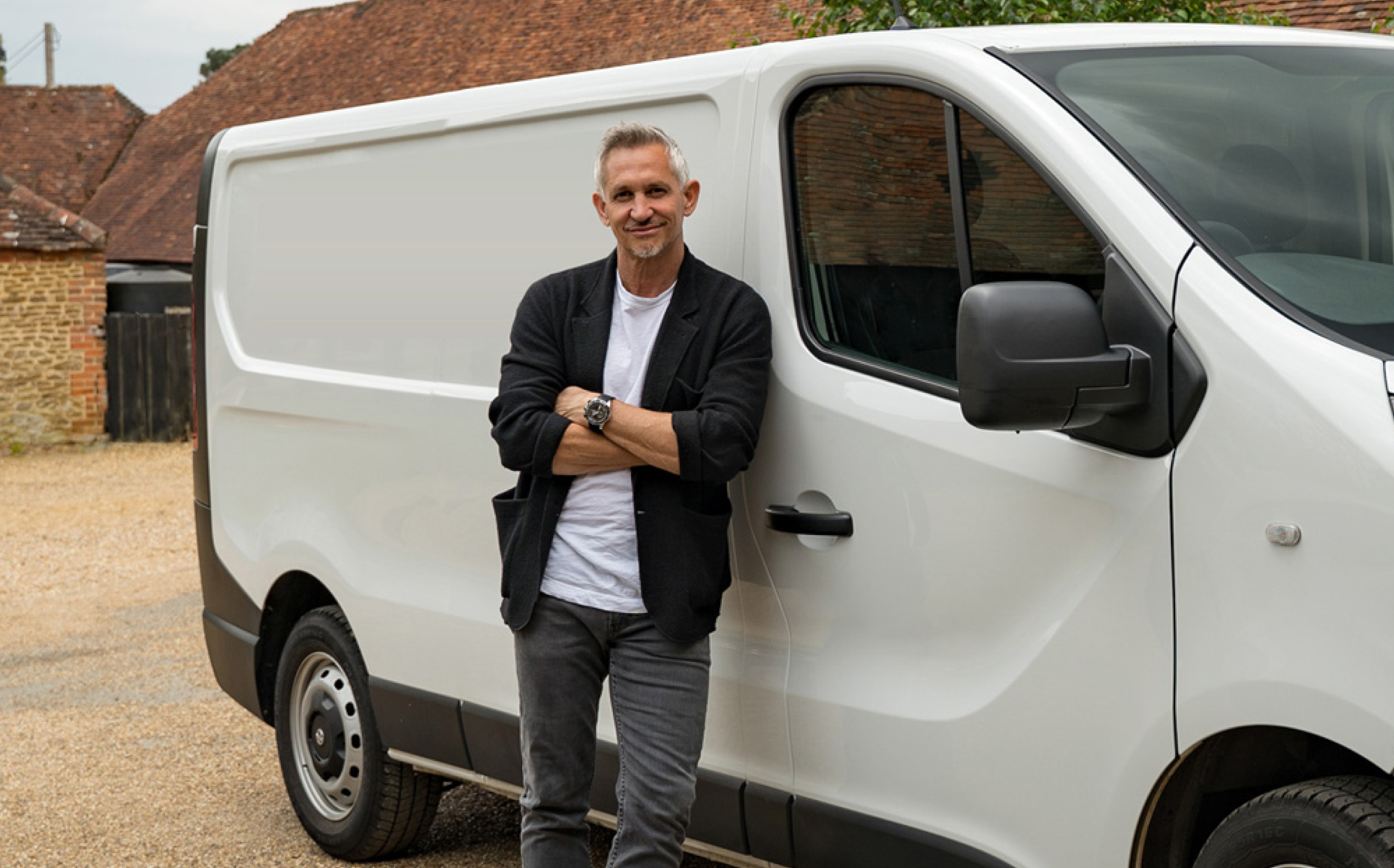 Gary Lineker stood next to a van